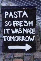 Copenhagen, Denmark A street sign or advertisment for a restaurant says: "Pasta so fresh it was made tomorrow."