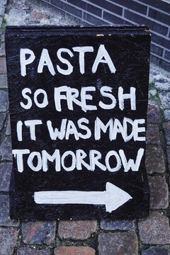 Naklejki Copenhagen, Denmark A street sign or advertisment for a restaurant says: "Pasta so fresh it was made tomorrow."