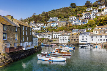 Fototapeta na wymiar Boats in the harbour at Polperro, a charming and picturesque fishing village in south east Cornwall. It is a truly delightful place to visit.