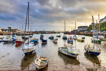 Fototapeta na wymiar A summer sunrise at the picturesque Brixham harbour on the south coast of Devon.