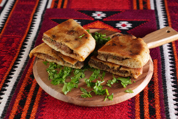 An Egyptian food hawawshi or hawawshy is a classic of spiced meat baked in bread served with tahina
