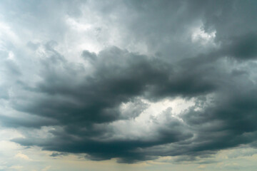 Fototapeta premium A terrible black cloud hangs in the sky before the rain. Bad weather. Hurricane and thunder over the city. Climate change and natural disasters. Bad mood and despondency.