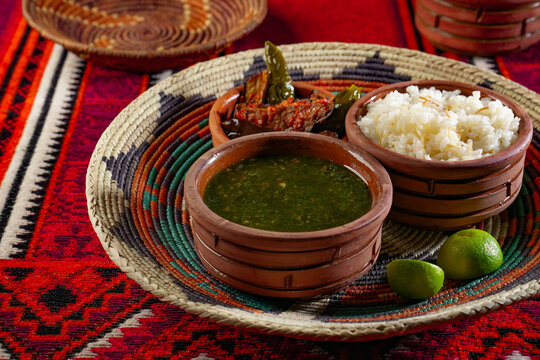 Famous traditional Egyptian cuisine. Molokhia soup with on egyptian background. Flat lay. Moroheiya, Mulukhiya