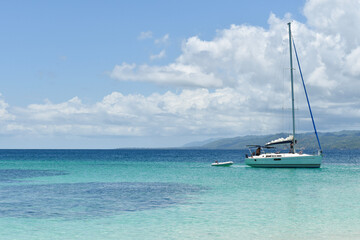 Beautiful bay with a sailing boat on the Caribbean beach. Cayo Levantado Island, Samana Bay, Dominican Republic.