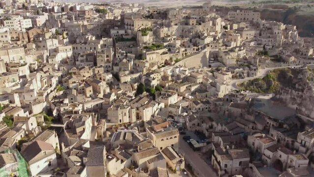 Aerial footage of Sassi di Matera, Basilicata, South Italy.Drone view of Sasso Caveoso and Civita districts, old city houses carved in rock caves, bell tower of Cathedral, Unesco heritage from above