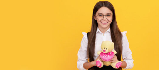 Love you. Happy child smile holding teddy bear. Valentines gift. February 14. Valentines day. Banner of child girl with toy, studio portrait, header with copy space.