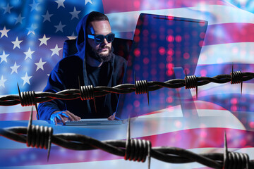 American hacker near barbed wire. Man with computer and USA flag. Arrest for cyber crime in USA concept. Criminal case against hacker in USA. Accounting hacker faces arrest. Ransomware development