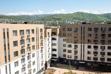 the courtyard of a new multi-storey house with a playground view from the window