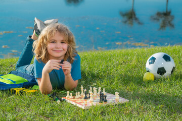 Dream kids and childhood concept. Chess game for children. Kid playing chess. Games and activities...