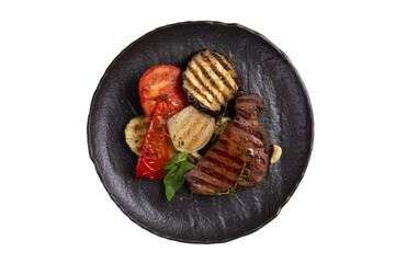 Steak and grilled vegetables in a plate. Transparent.