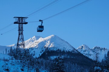 Ropeway to Kasprowy Wierch Peak in Tatras Mountains in beautiful winter scenery in morning light,...
