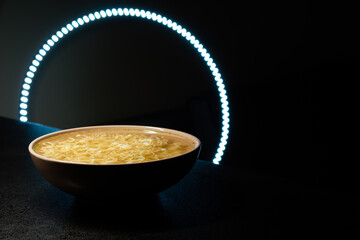 Noodles. restaurant design. Instant egg noodles on a black background on a plate. with led backlight
