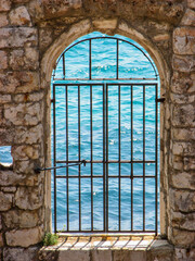 A window in the walls of Dubrovnik's fortified city walls, overlooking the Adriatic Sea.