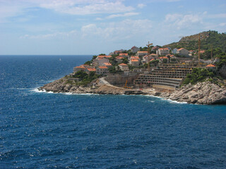 A view off Dubrovnik's coast on a sunny day with a blue sky.  Image has copy space.
