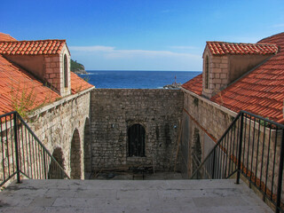 A part of Dubrovnik's city wall overlooking the Adriatic Sea on a sunny day with a clear blue sky.  Image has copy space.