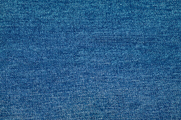 Close-up of blue jeans texture with. Denim textile background. Clothes fabric backdrop.