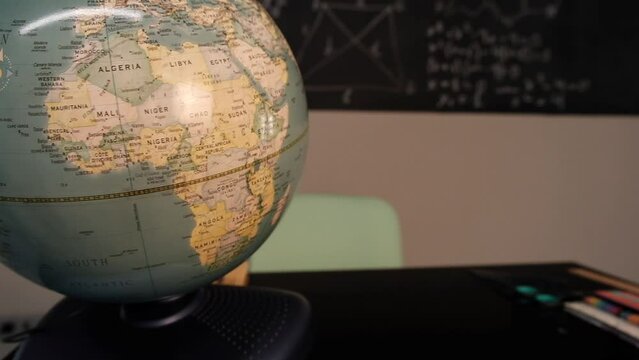 spin the globe on the table at school