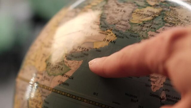 Africa on globe map
 shows a finger
