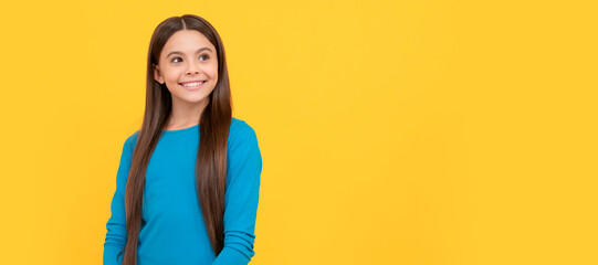 positive child with long hair on yellow background, fashion. Child face, horizontal poster, teenager girl isolated portrait, banner with copy space.