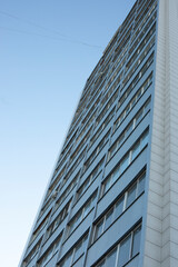 Obraz premium Grey building in city. High house. Windows in residential building.