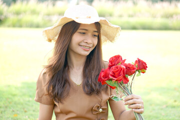 Asian woman smiling happily green grass background