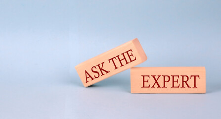 ASK THE EXPERT text on the wooden block, blue background