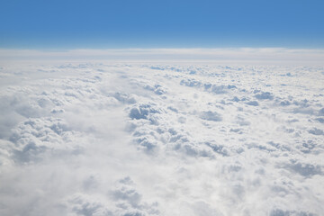 Clouds outside the window in an airplane in flight