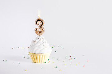 Birthday cupcake with number four candle on white background