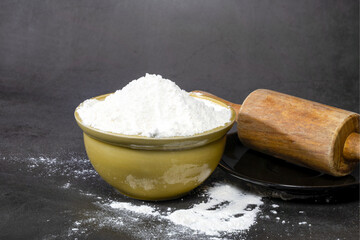 A brown ceramic bowl with all-purpose flour powder