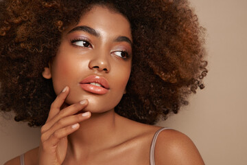 Beauty portrait of African American girl with afro hair. Beautiful black woman. Cosmetics, makeup and fashion