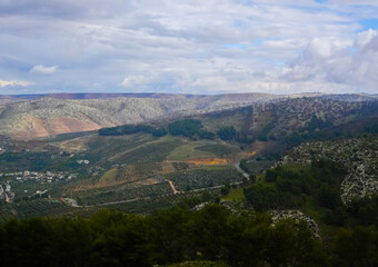 Fototapeta na wymiar umm qais - irbid, jordan 06- Feb- 2023 - green rocky mountains at jordan- irbid