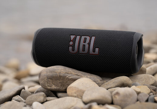 LVIV, UKRAINE - OCTOBER 12, 2022: JBL Flip 6 Black, Portable Bluetooth Speaker Outdoors.