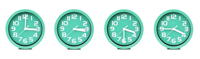 close up of a set of green clocks showing the time; 3, 3.15, 3.30 and 3.45 p.m or a.m. Isolated on white background