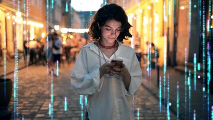 Beautiful Woman Using Smartphone on a City Street at Night. Wireless communication network concept. Visualization of the Internet by information lines flying to the global digital network - Powered by Adobe