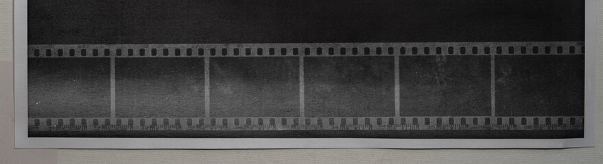 empty 35mm filmstrip printed on dark copy paper material. toner test print.