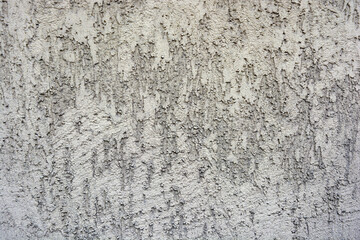 Building backgrounds, wall cladding made with brown textured and structural plaster in the form of bark on the wall of one of the houses in the city of Dnipro, Ukraine.
