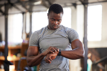 Fototapeta na wymiar Fitness, smartwatch and black man in gym for training, workout or exercise results, monitor or progress update, Check, timer and bodybuilder athlete or sports person technology in health and wellness
