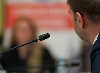 Speakers. The person speaking in front of a room, presentation. interior photo.