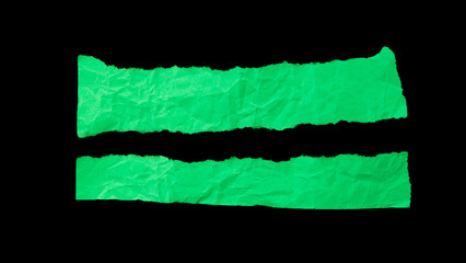 Green crumpled torn paper pieces isolated on black background