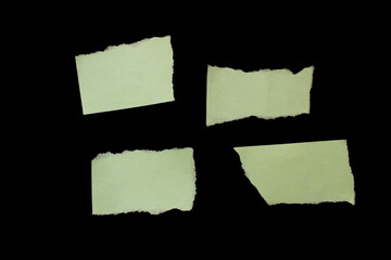 Torn paper piece isolated on black background