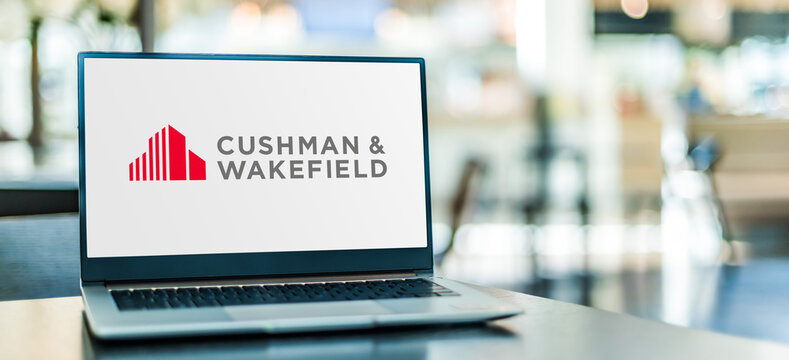 Laptop computer displaying logo of Cushman and Wakefield