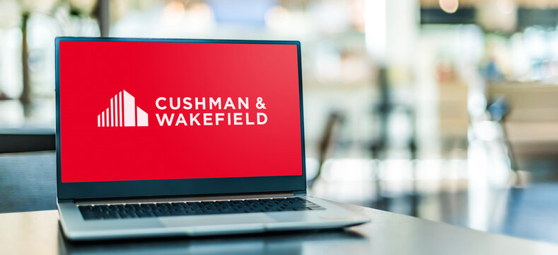 Laptop computer displaying logo of Cushman and Wakefield