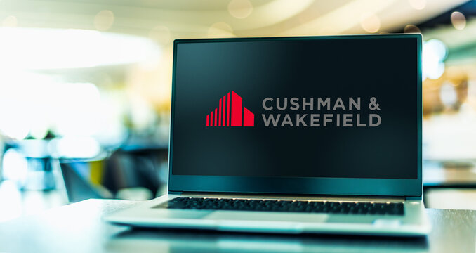Laptop computer displaying logo of Cushman and Wakefield