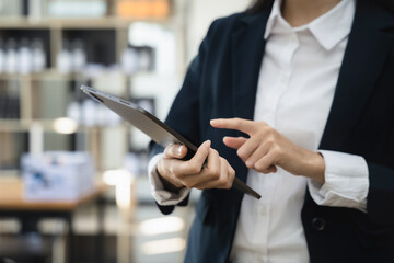 Business woman using tablet and stock market charts.