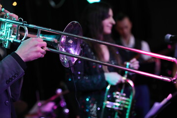 Group of jazz musicians playing on the stage on a wind musical instrument trumpet bell close up