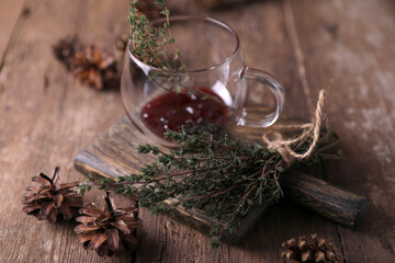 Tea with jam and thyme in a transparent teapot