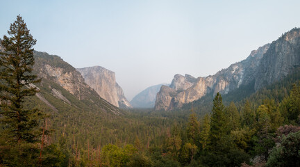 Panoramic view of Tunnel View with some smoke between the mountains, in Yosemite NP