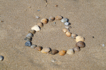a heart made of seashells on the sandy beach of Baltrum Island in the North Sea in Germany	