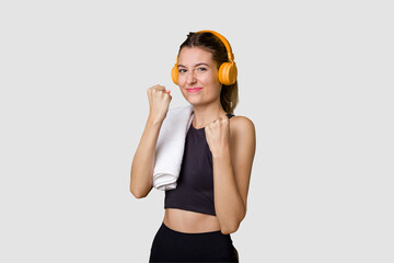 A young sportswoman enjoying music on her mobile phone, fueled with motivation