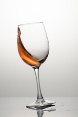 Splash of rose wine in glass, frozen motion